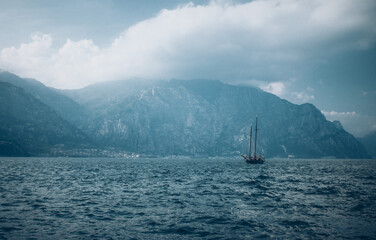 Lonely Sailing Ship with Mountain Backdrop on Garda Lake Italy