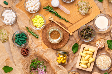 Homeopathy and alternative medicine. Meds, pills, capsules, supplements in small bowls on a wooden desk from above in rustic style. Top view homeopathic meds, flat lay still life.