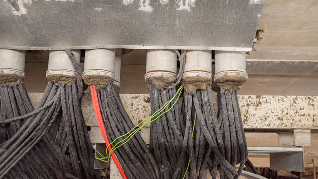 Electrical Wiring Close-Up. A close-up image of electrical wiring and conduits, showing the intricate network of cables and connections.