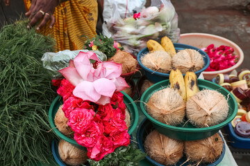 Indian lotus and marigold flowers wit coconut selling at street near Hindu temple Madurai Tamil Nadu India. Flowers for Pooja prayers