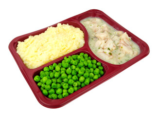 Cod fish in parsley sauce ready meal with mashed potato and green peas in a sectional plastic tray