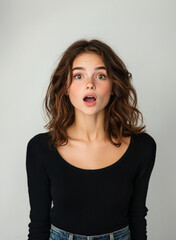 Obraz premium A brunette woman posing surprised expression , radiating happiness and beauty.