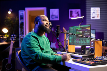 Talented artist composer writing a new track on paper, thinking about rhymes and words to blend together. Singer musician producing new songs in home studio, working on soundtrack chorus.