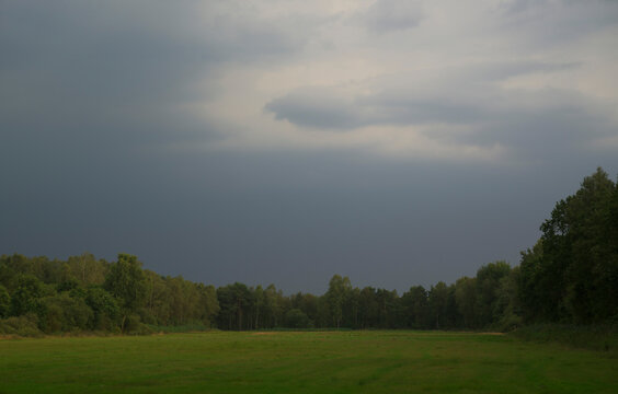 Thunderstorm clouds approaching over agricultural field