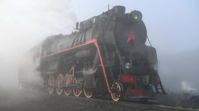 An old Soviet steam locomotive in the morning fog. Sortavala, Karelia