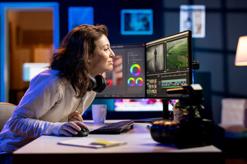 Smiling video editor selecting key frames to use while doing video montage, using specialized program. Happy videographer using editing tools on computer to cut movie project footage in office