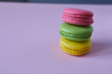 Colorful macaroons on a pink background. Selective focus.