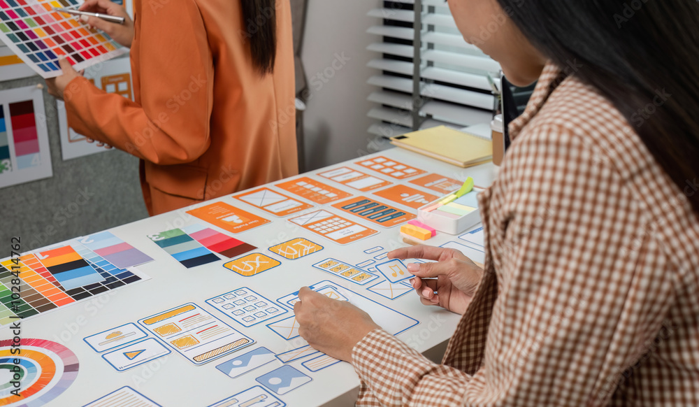 Wall mural team of program developer collaborating on uxui design planning in a modern office environment