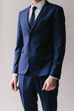 Detail of man in dark blue suit.
