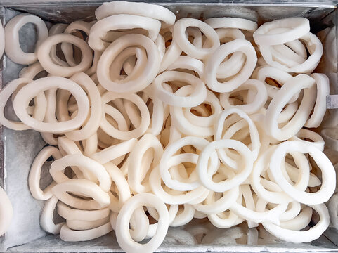 Squid rings. Frozen squid seafood in fish market. Frozen squid background.