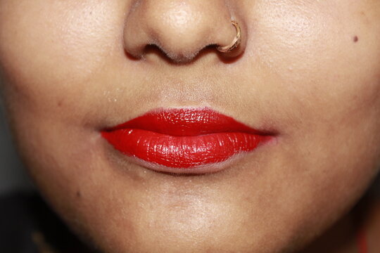 Perfect natural lip makeup. Close up macro photo with beautiful Indian teenage girl mouth. A close view of naturally peach-colored, soft human lips, highlighting their delicate texture and natural bea