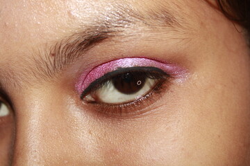 Obraz premium Macro photograph of pink colour eyeliner paired with metallic eyeshadow, highlighting the sharpness the reflective quality of the shadow.