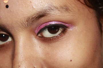 Fototapeta premium Macro photograph of pink colour eyeliner paired with metallic eyeshadow, highlighting the sharpness the reflective quality of the shadow.
