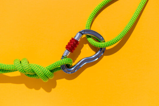 two ropes with secure knots are connected by a carabiner. Equipment for rock climbing and mountaineering. reliable connection. concept of reliability and strength.