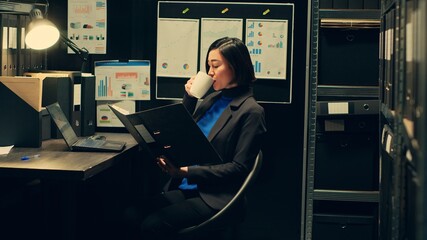 Law officer reading case evidence files to cross examine details, doing federal detective work from...