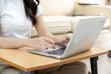 Asian woman having online meeting on laptop