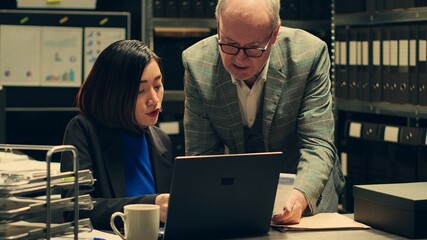 Team members investigating authenticity of historical documents and legal information, looking into...