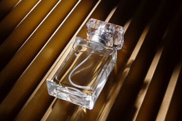 Perfume bottle on geometric background in hard light