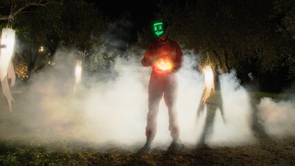 Anonymous Man Mask In A Scary Foggy Forest At Night Halloween