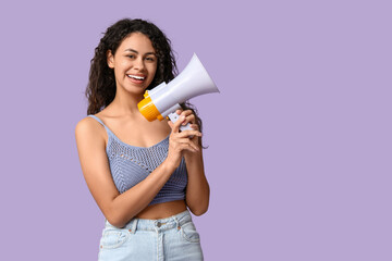 Young African-American woman with megaphone on lilac background