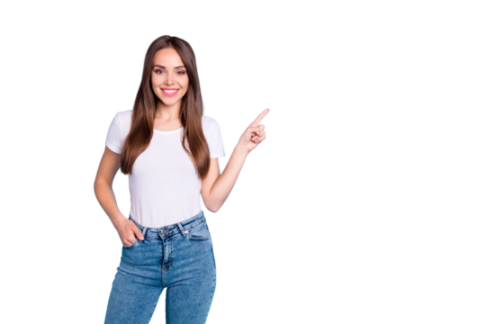Portrait of charming confident person showing adverts pointing at copy space wearing white t-shirt denim jeans isolated over blue background