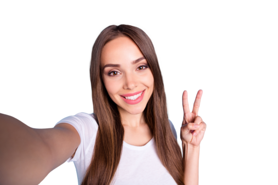 Close up photo of cheerful lady making photos v-signs wearing white t-shirt isolated over blue background