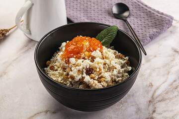 Curd with granola and orange jam