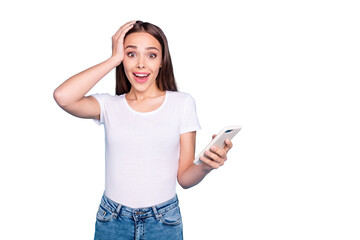 Portrait of impressed cute lady screaming wow omg touching her head wearing white t-shirt jeans isolated over blue background