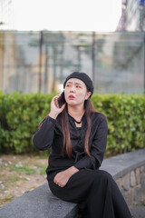 A Japanese woman in her 30s is enjoying a relaxing afternoon at a stylish cafe's terrace in Gyeongchun-ro, Namyangju-si, Gyeonggi-do, Korea.