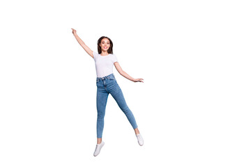 Full body photo of cute youngster raising arms up wearing white t-shirt denim jeans sneakers isolated over blue background