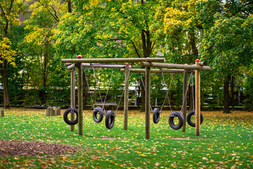 View of a swing made from car tires on a playground