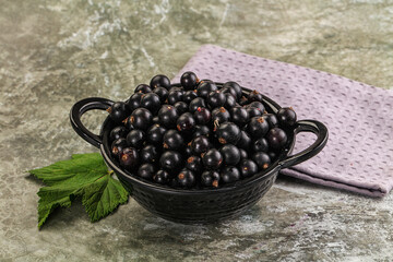 Ripe black currant in the bowl