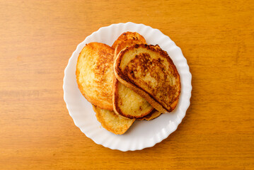 Close-up of baguette croutons, Toasts, bruschetta from sliced baguette, close up, white plate.