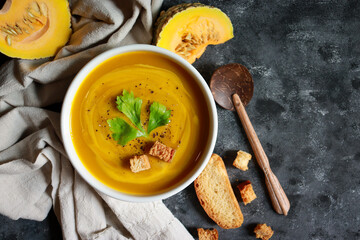 Creamy pumpkin soup in a bowl. Healthy food in Autumn season.