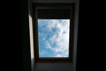 Window with a wooden frame and a blue sky outside