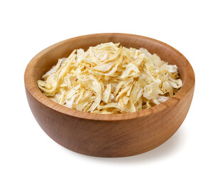 Dried onions in a wooden plate on a white background. Isolated