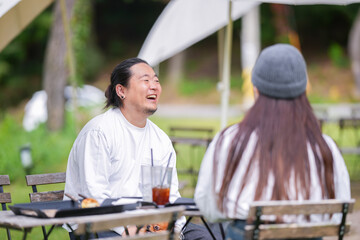 A Korean man and a Japanese woman, both in their 30s and a married couple, are enjoying an autumn...