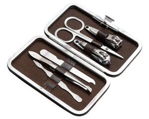 An open grooming kit featuring stainless steel manicure and pedicure tools neatly organized in a brown leather case. The kit includes nail clippers, scissors, tweezers, and a nail file.