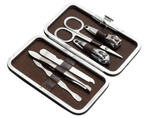 An open grooming kit featuring stainless steel manicure and pedicure tools neatly organized in a brown leather case. The kit includes nail clippers, scissors, tweezers, and a nail file.