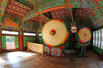 Mungyeong-si, Gyeongsangbuk-do, Korea - October 18, 2014: Wide angle view of the wooden drums with colorful dancheong of the ceiling in Gimlyongsa Temple