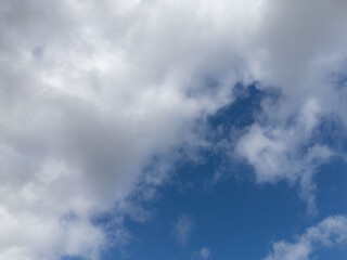 Vibrant clouds against a deep blue sky create a stunning natural backdrop. This crisp, high-resolution image captures the fluffy white clouds floating gracefully, perfect for backgrounds, nature-theme