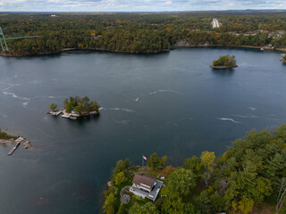Fototapeta premium Tranquil aerial view of the 1000 Islands region, showcasing scattered islands on serene waters under a vast sky, capturing natural beauty and peacefulness.