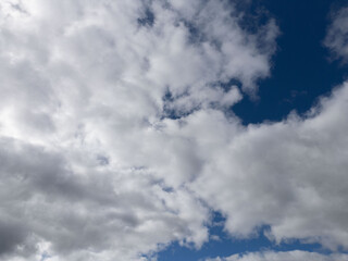 Vibrant clouds against a deep blue sky create a stunning natural backdrop. This crisp, high-resolution image captures the fluffy white clouds floating gracefully, perfect for backgrounds, nature-theme