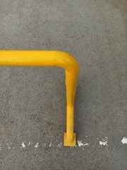 Yellow handrail on the cement floor with copy space for add text