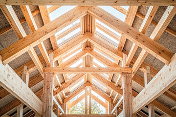 The wooden beams of a building are visible from the inside