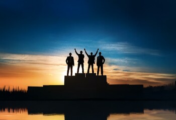 Fototapeta premium Four businessmen stand on a platform, arms raised, silhouetted against a sunset.