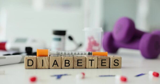 Diabetes text with syringe and pills on table in clinic. Diseases of endocrine system caused high blood sugar