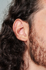 Fototapeta premium Profile view of a man with curly hair and a beard
