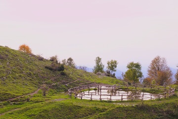 Watering hole with fence, in the Italian mountains. Morterone, Lombardy, Italy
