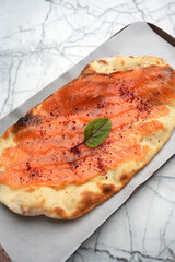 Smoked salmon pizza with pita bread, top view
